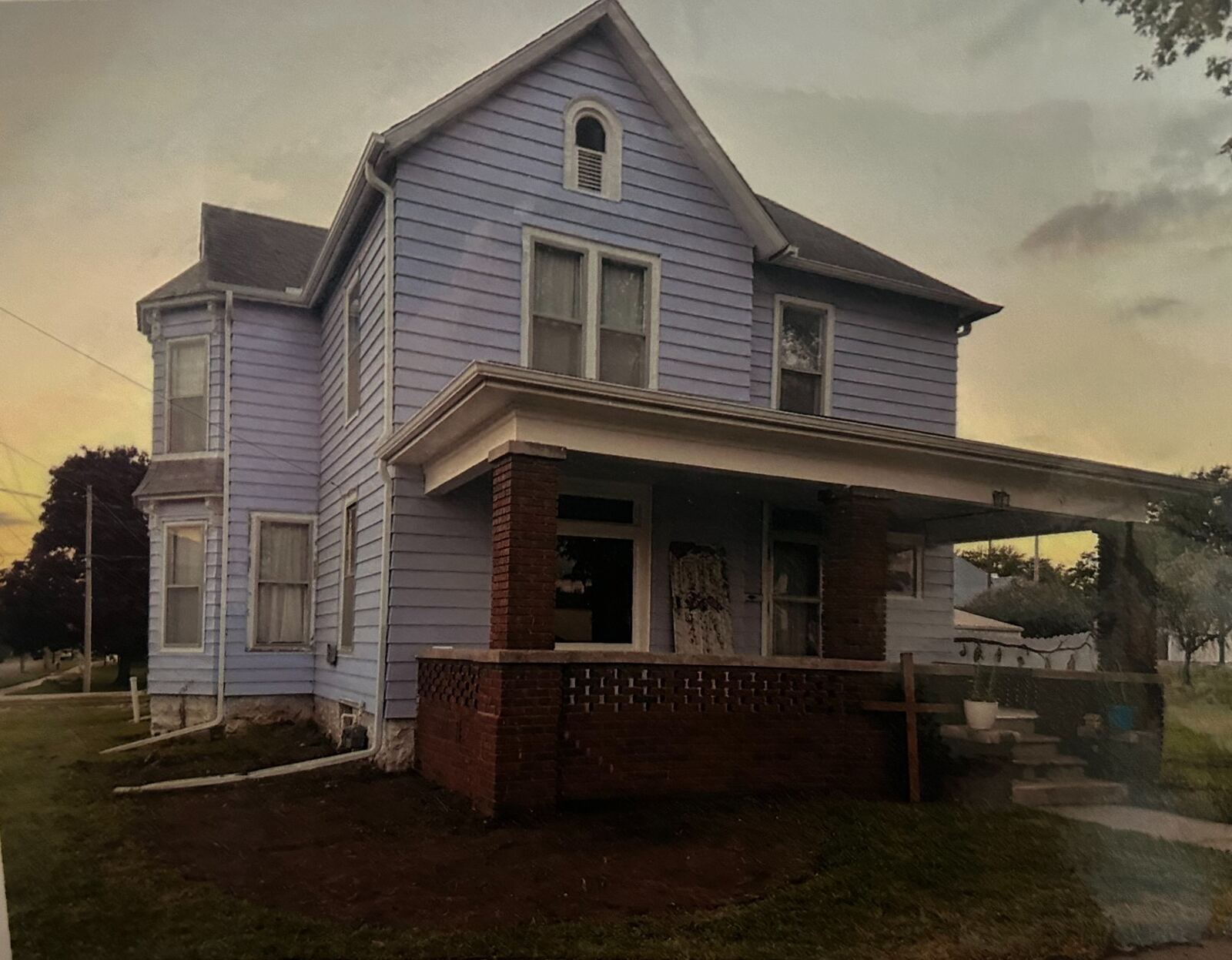 The lavender Grace and Purpose Home at dusk