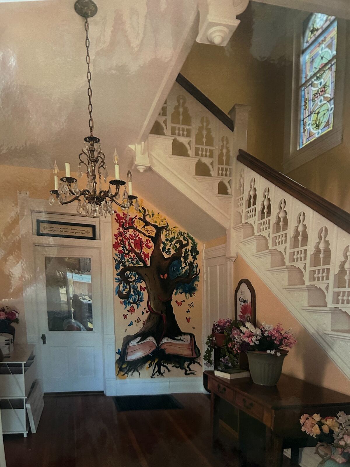 Staircase and tree-of-life mural inside GAP House